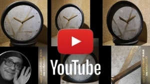 Guarda su youtube: Orologio da parete moderno con fondo beige e disegno geometrico a rete dorato.
